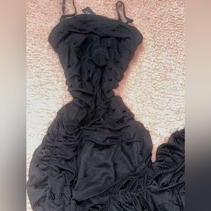 Black runched sleeveless with slit and black pearls dress